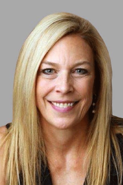 Professional portrait of a smiling blonde woman in dark clothing