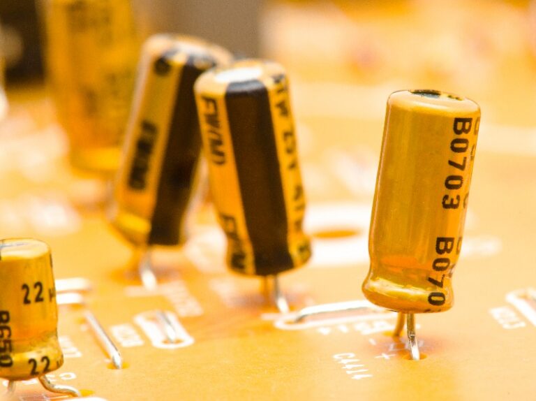 Close-up of gold electrolytic capacitors on a printed circuit board