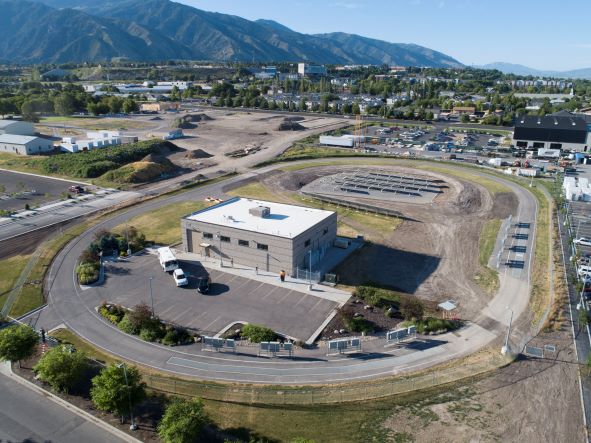 Aerial view of an oval test track encircling a building at an ASPIRE research facility