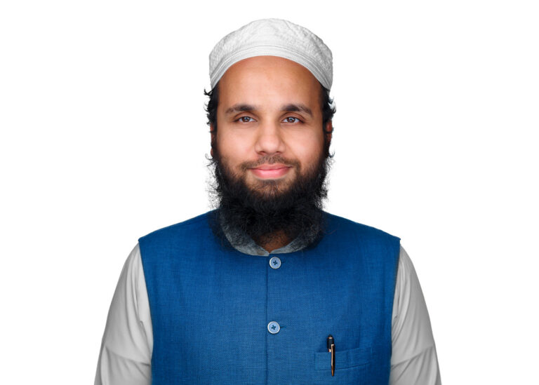 Professional portrait of Abdullah Zubair Mohammed in a blue vest and white cap