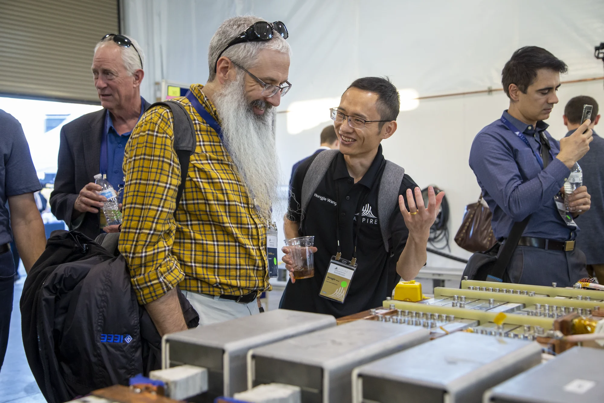 Attendees examining an exhibit at the ASPIRE annual meeting